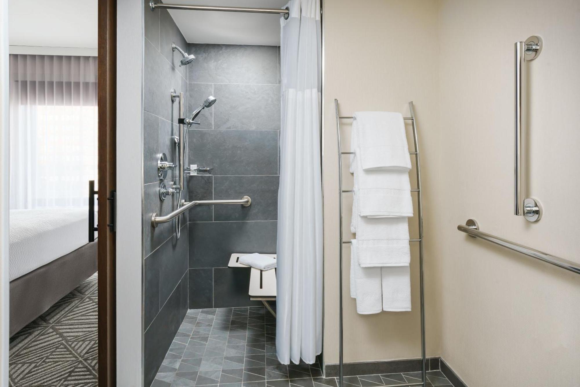 Estudio adaptado para personas con movilidad reducida y discapacidad auditiva con ducha accesible en silla de ruedas - Cama extragrande